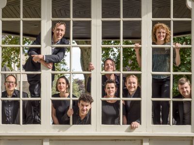 EXAUDI Vocal Ensemble pictured behind a square grid